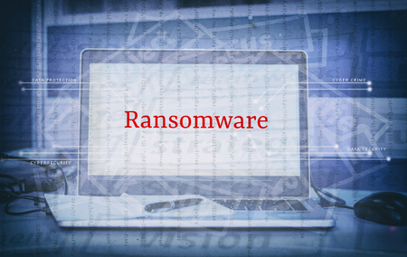Cyber crime and threat concept with word RANSOMWARE display on laptop screen and abstract backgroundの写真素材