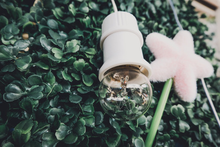 cropped image, simple decoration with green artificial turf, star and bulbの写真素材