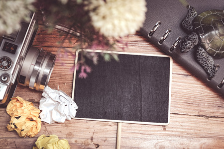 travel and vacation concept, vintage camera, crumple paper,compas and planner book layout on wooden...