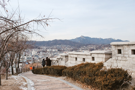 unidentified people walk surrounded by beautiful Korea nature at hill top during winter seasonの写真素材