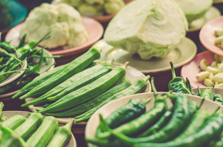 Various vegetables display on wooden table for sale at fresh market stall with faded color effect.selective focus shotの写真素材
