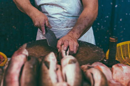 Fresh market scene in Malaysia, fish monger clening his fish before selling activityの写真素材