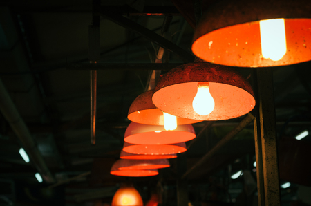 light lamps hanging from the ceiling.selective focus shot  and image might contain grain and noiseの写真素材
