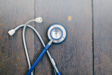 Stethoscope over wooden background for medical and health care conceptの写真素材