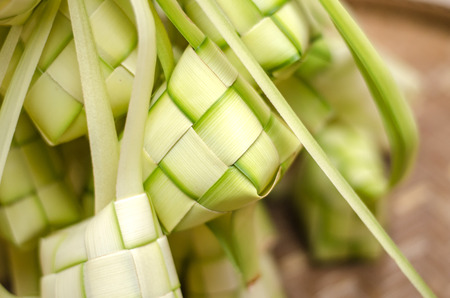 ketupat casing and rice in bamboo container. traditional malay delicacy during Malaysian eid festivalの写真素材