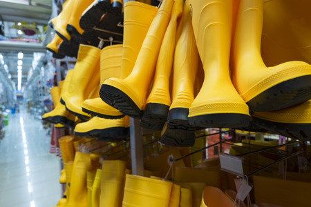 yellow rubber boots display for sale in hardware storeの写真素材