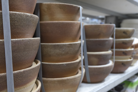 Stacking clay pot on rack display for sale in hypermarket.の写真素材