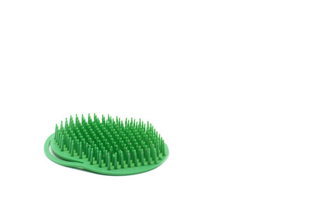 plastic green comb isolated on white background for home usageの写真素材