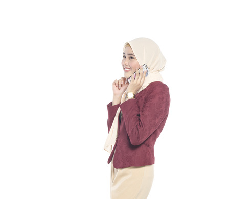 Communication and technology concept,pretty hijab woman with happy face, make a phone call isolated on white backgroundの写真素材