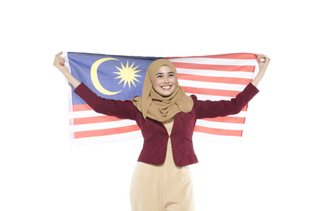 young malaysian civilian with happy face celebrating independent day. hand holding flag.isolated white backgroundの写真素材