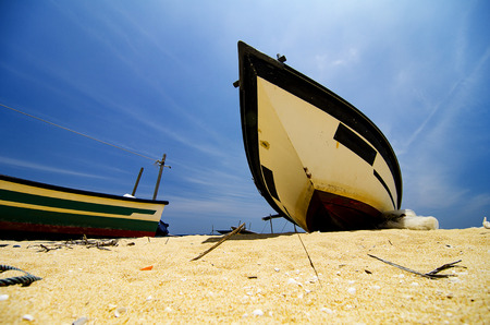 Beautiful scenery, traditional fisherman boat moored over beautiful sea view and sandy beach under bright sunny dayの写真素材