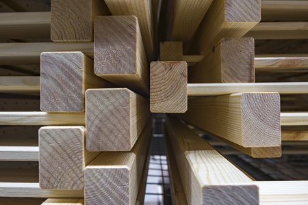 grainy background image,pile of wood stack for D.I.Y furniture stored at warehouse shot under low light.の写真素材