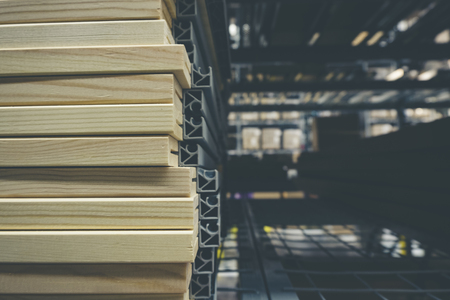 grainy background image,pile of wood stack for D.I.Y furniture stored at warehouse shot under low light.の写真素材