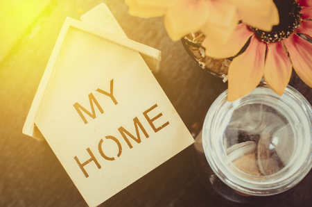 miniature wooden house with signage for real estate and mortgage conceptの写真素材