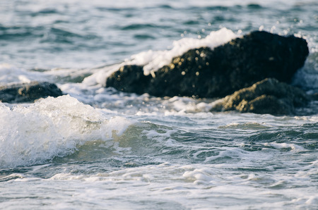 Beautiful nature, splashing wave while hitting the rock at the beach