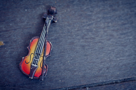 Music passion and hobby concept, violin miniature on wooden floor with retro color tone.copy space on the right for textの写真素材
