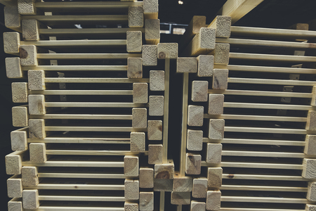 grainy background image,pile of wood stack for D.I.Y furniture stored at warehouse shot under low light.の写真素材