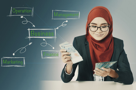 happy expression young business woman holding money for busness success concept word conceptの写真素材