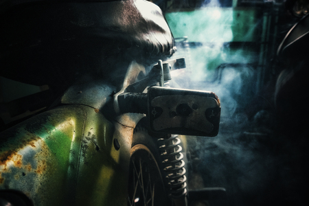 closeup abstract background, rusty old motorcycle under low light with noise, grain and smoke effect の写真素材