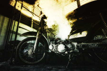closeup abstract background, rusty old motorcycle under low light with noise, grain and smoke effect の写真素材