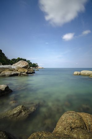 long exposure shot of idyllic tropical island scenery with crystal clear turquoise water and blue sky background.の写真素材