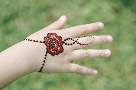 Artist applying henna tattoo on women handの写真素材