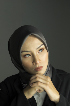 Portrait of aggrassive and confident expression young grinning professional womanの写真素材