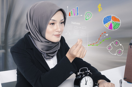 Creative ideas concept with abstract background, young student sitting and look in front. book, and vintage clock on tableの写真素材