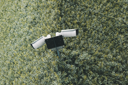 Concept of surveillance and monitoring, modern cctv camera attach to the wall