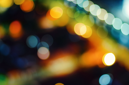 abstract defocus of colorful glittering shine bulbs lights backgroundの写真素材