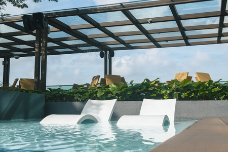 sunbath chair in the pool ideal for travel and vacation conceptの写真素材
