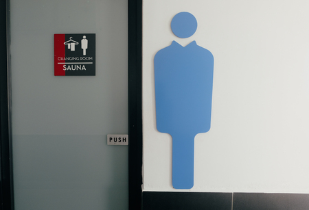 men changing room and sauna direction at public swimming poolの写真素材