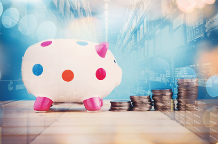 Concept savings with piggy bank and stacked coins agains double exposure backgroundの写真素材