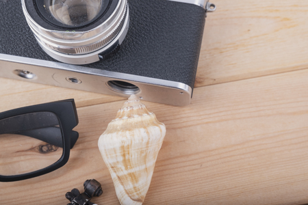 top view flat lay travel concept with camera, sunglases and other miniature on wooden deskの写真素材