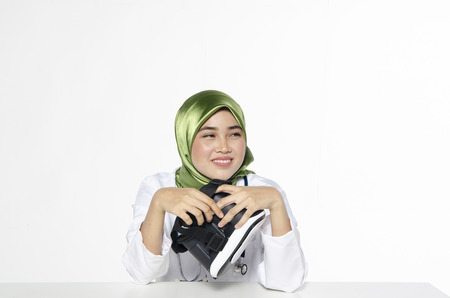 Smiling optimistic young women doctor with hijab,for healthcare practitioner profession, people and medicine concept.の写真素材