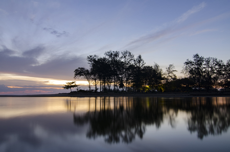 Travel and leisure concept, beautiful sea view scenery over stunning sunrise background.sunlight beam and soft wave hitting sandy beachの写真素材