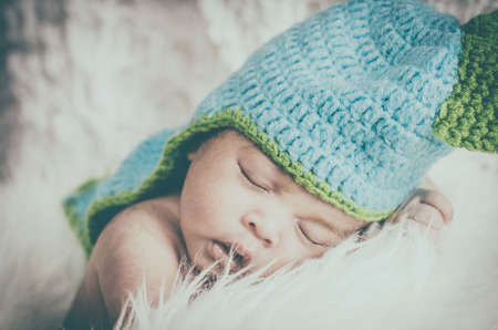 Close-up shot,cute and adorable newborn baby with costume sleeping.New life and parenting concept.の写真素材