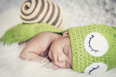 Close-up shot,cute and adorable newborn baby with costume sleeping.New life and parenting concept.の写真素材