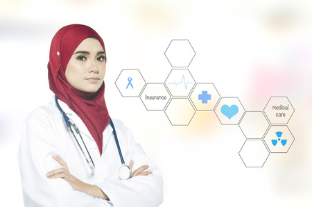 Portrait of a lovely practitioner doctor standing and smile over abstract backgroundの写真素材