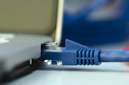 Closeup ethernet cable connected to the Lan port on laptop for computer network conceptの写真素材