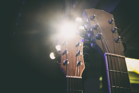 close-up and selective focus shot image of acoustic guitar on a wooden background.copy space on the...