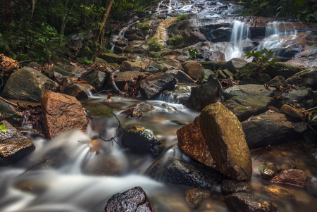 Beautiful tropical waterfall in lush surrounded by green forest.wet rock and moss.selective focus...