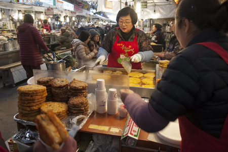 SEOUL, SOUTH KOREA 24 JANUARY 2019: Workers at Gwangjiang Market street food stall , South Korea.The Best places to experience traditional Korean street foodのeditorial素材