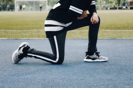 Sport and healthy lifestyle concept. cropped image of young sportswoman stretching and having some warming up before runningの写真素材