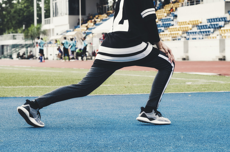 Sport and healthy lifestyle concept. cropped image of young sportswoman stretching and having some warming up before runningの写真素材