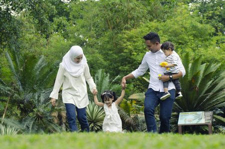 happy family concept with enjoying expression face,having fun at public park.の写真素材