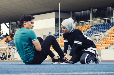 Sport and healthy lifestyle concept. young athlete stretching and having some warming up before runningの写真素材