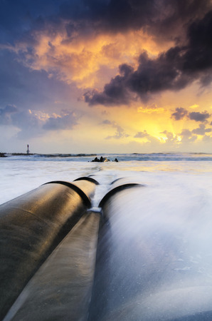 Travel And vacation concept background, beautiful tropical beach sunrise sea view. soft wave hitting sandy beachの写真素材