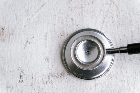 Healthcare and medical concept, stethoscope on wooden table.selective focus shot and grain effectの写真素材