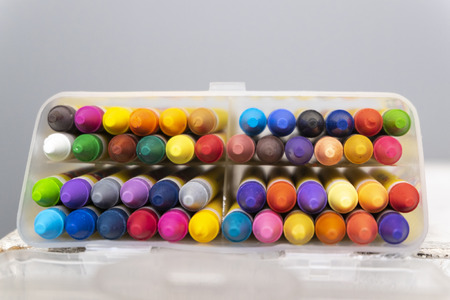 education and back to school concept, colorful crayons in the transparent box.selective focus shot...